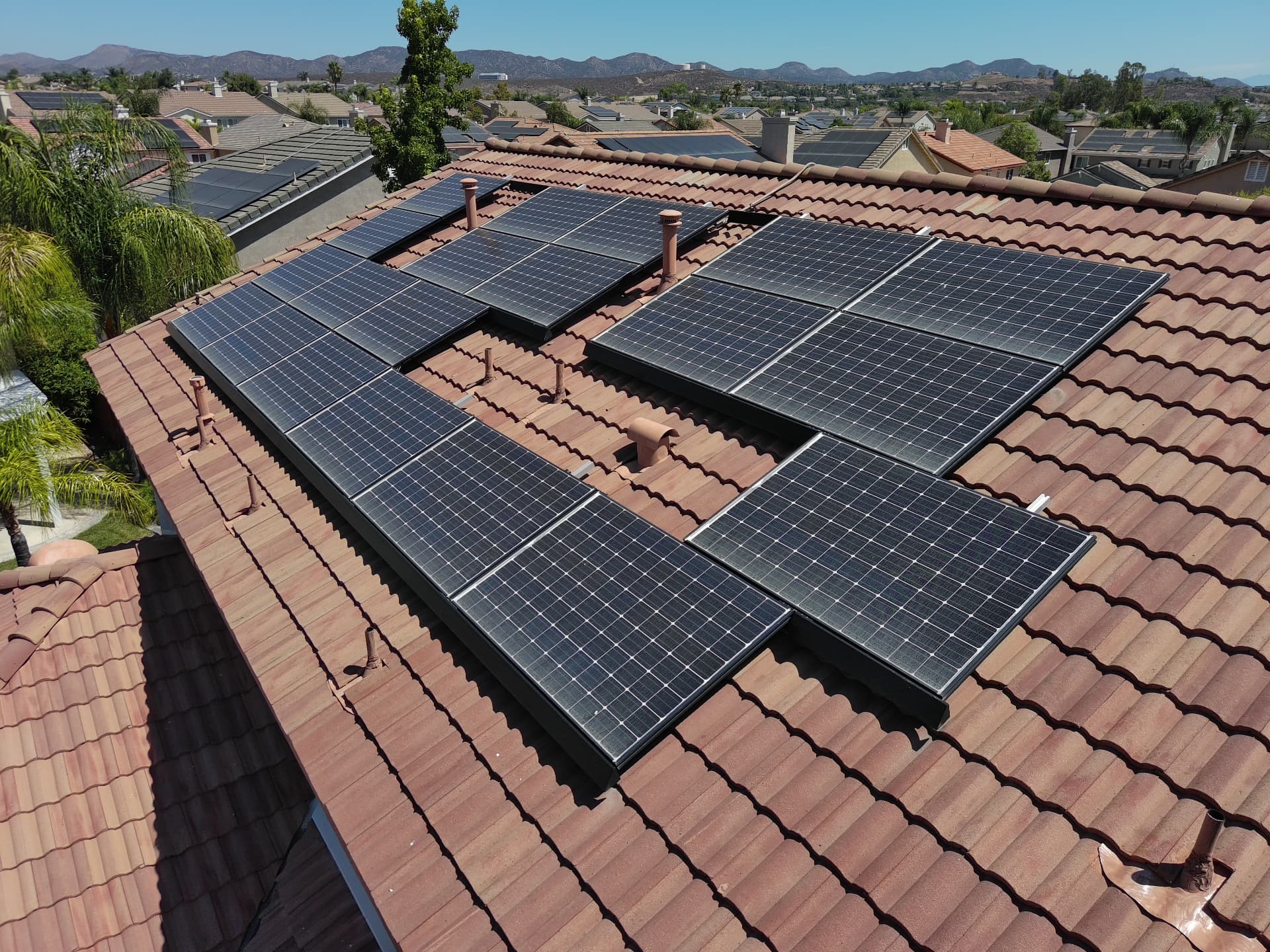 Solar array on a tile roof in a San Diego hillside neighborhood, photographed during a home inspection