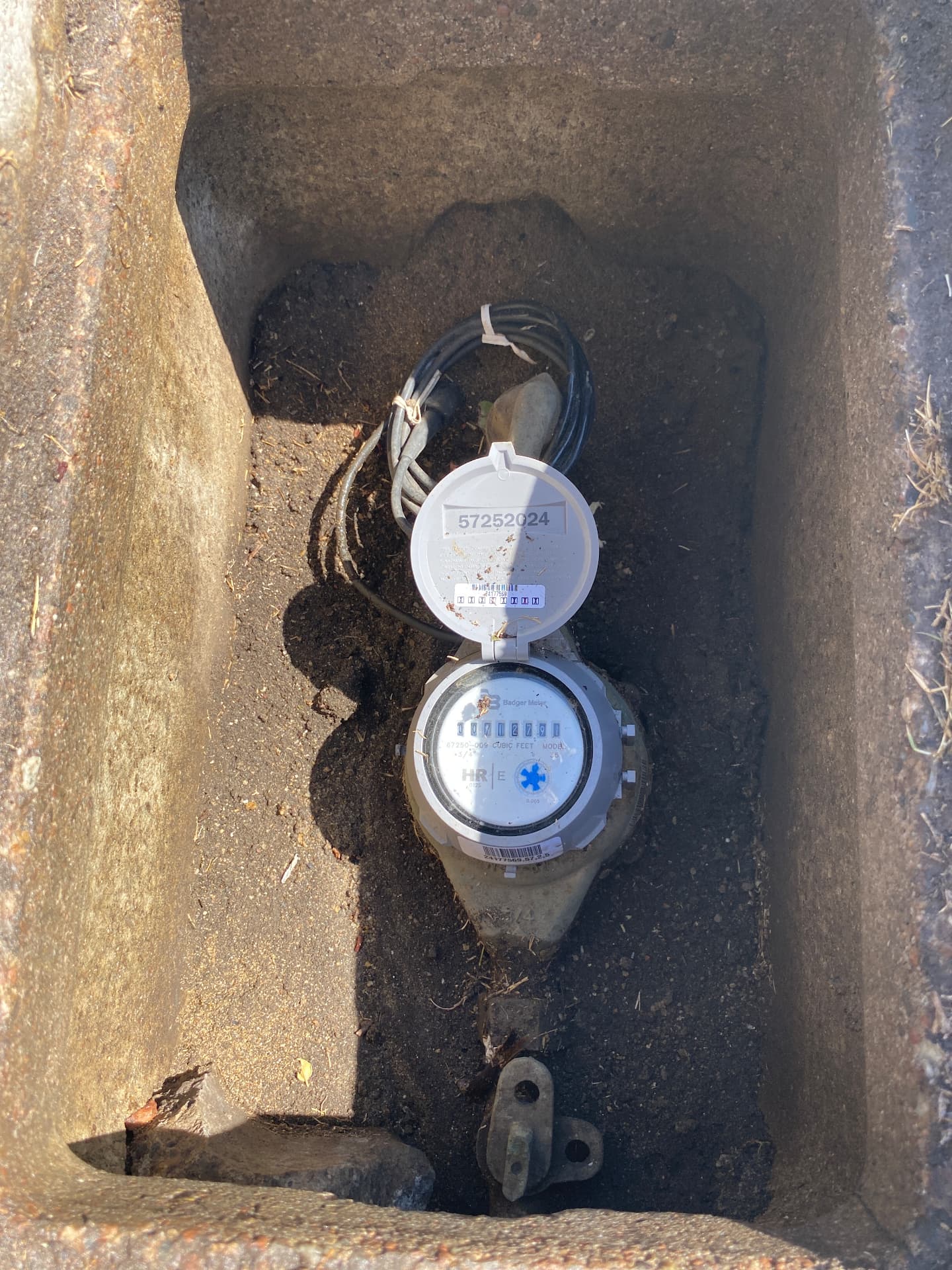 Open water meter box showing a Badger water meter used to check for hidden plumbing leaks