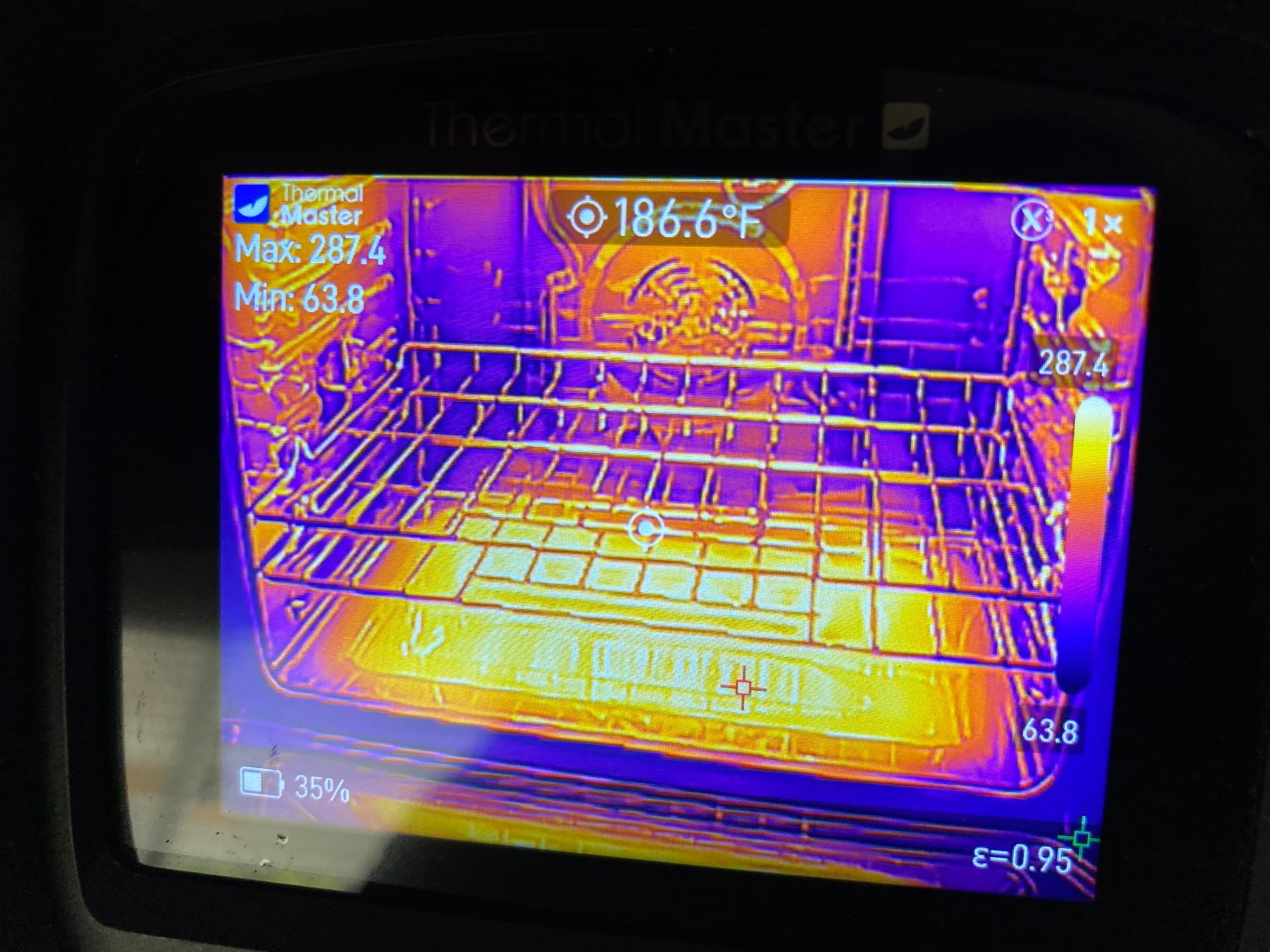 Thermal imaging camera screen showing heat distribution inside an oven during appliance testing